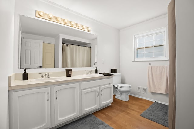 full bath with a sink, baseboards, visible vents, and wood finished floors