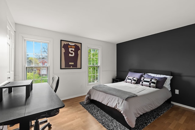 bedroom featuring baseboards and wood finished floors