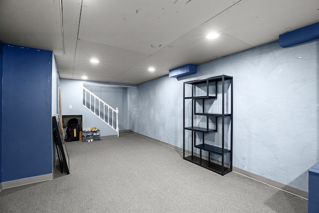 finished below grade area with carpet, stairway, baseboards, and recessed lighting