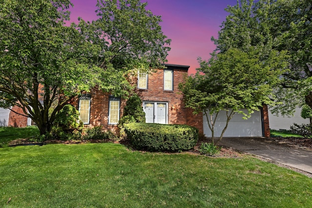 view of front of home featuring a garage, brick siding, driveway, and a lawn