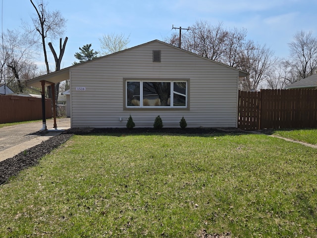 view of property exterior featuring fence and a yard