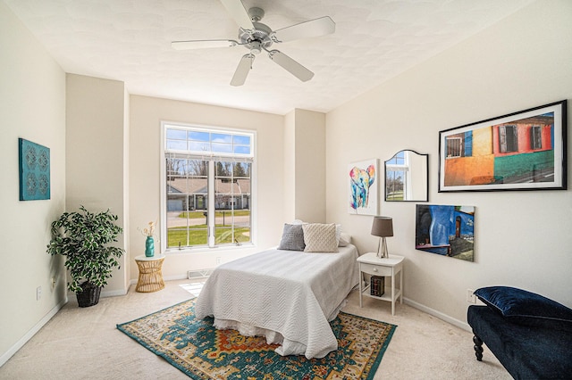 bedroom with carpet floors, a ceiling fan, and baseboards