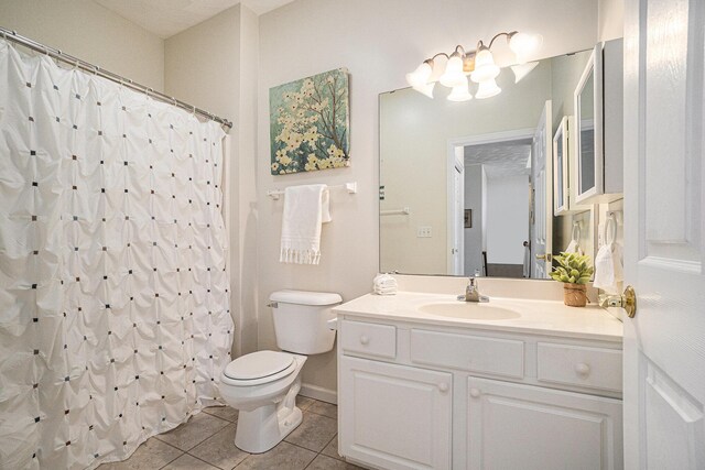 full bathroom featuring tile patterned floors, toilet, baseboards, a shower with shower curtain, and vanity