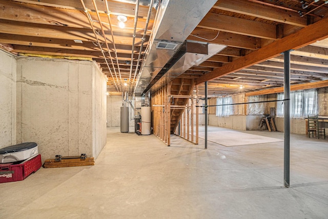 below grade area featuring water heater and visible vents