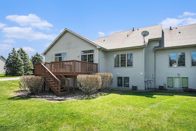 rear view of house with stairway, central AC, a lawn, roof with shingles, and a deck