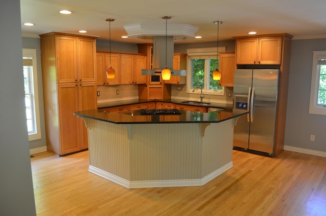 3629 Frederick Dr, Ann Arbor, MI 48105 - kitchen with stainless steel fridge, wall chimney exhaust hood, light wood-style flooring, healthy amount of natural light, and ornamental molding
