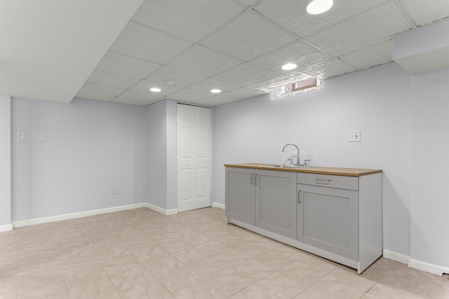 interior space with baseboards, a sink, and recessed lighting