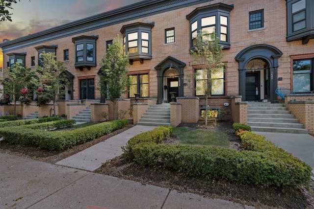 townhome / multi-family property with brick siding