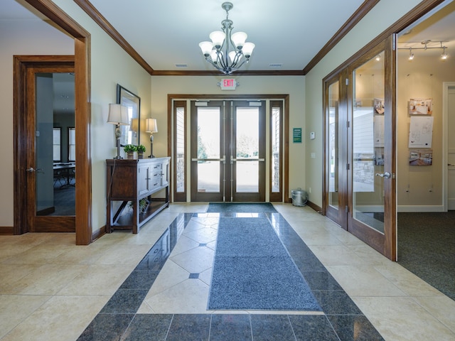 foyer entrance featuring french doors, baseboards, and an inviting chandelier