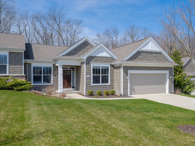 craftsman inspired home with a garage, a front lawn, roof with shingles, and concrete driveway