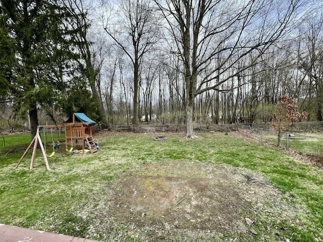 view of yard featuring fence and a playground