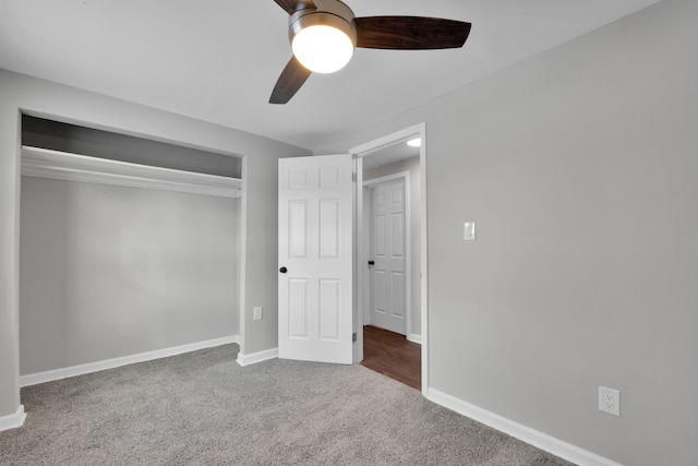 unfurnished bedroom featuring baseboards, carpet, a closet, and ceiling fan