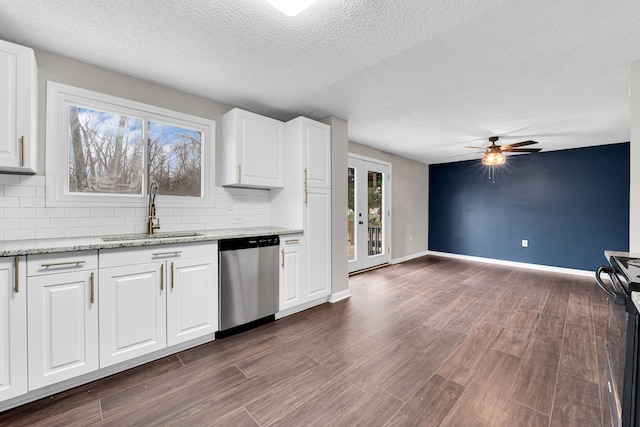kitchen featuring dishwasher, a sink, tasteful backsplash, electric range, and ceiling fan