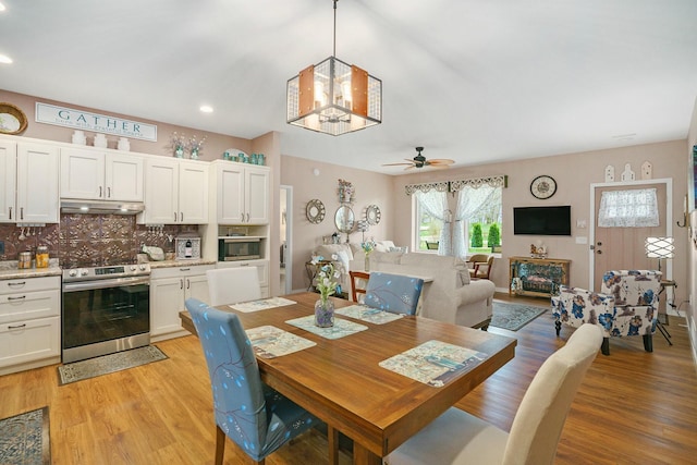 dining area featuring recessed lighting, light wood-style floors, and ceiling fan with notable chandelier