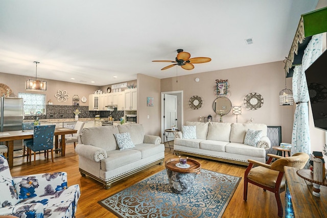 living area featuring recessed lighting, wood finished floors, visible vents, and ceiling fan
