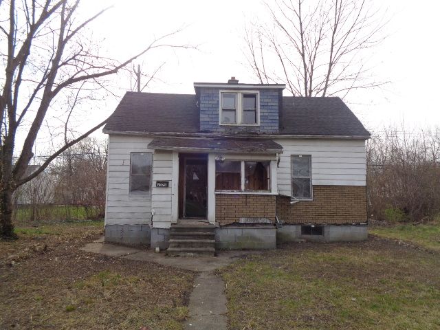 bungalow-style home with a chimney, entry steps, and a shingled roof