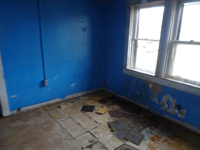 spare room with baseboards