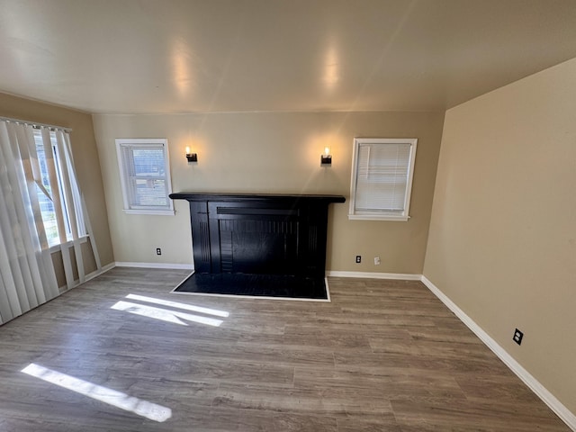 15241 Seymour St, Detroit, MI 48205 - unfurnished living room featuring a fireplace with flush hearth, wood finished floors, and baseboards