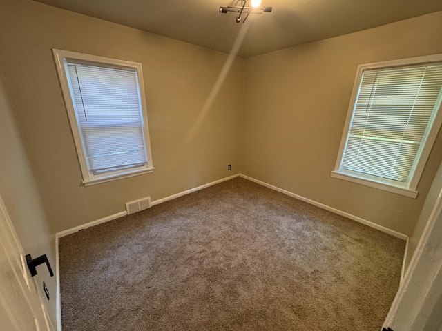 15241 Seymour St, Detroit, MI 48205 - unfurnished room with baseboards, visible vents, and carpet flooring
