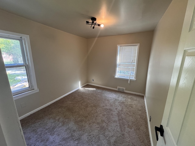 15241 Seymour St, Detroit, MI 48205 - empty room featuring visible vents, carpet flooring, and baseboards