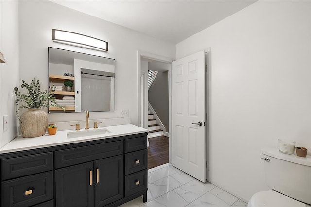 bathroom with vanity, marble finish floor, and toilet