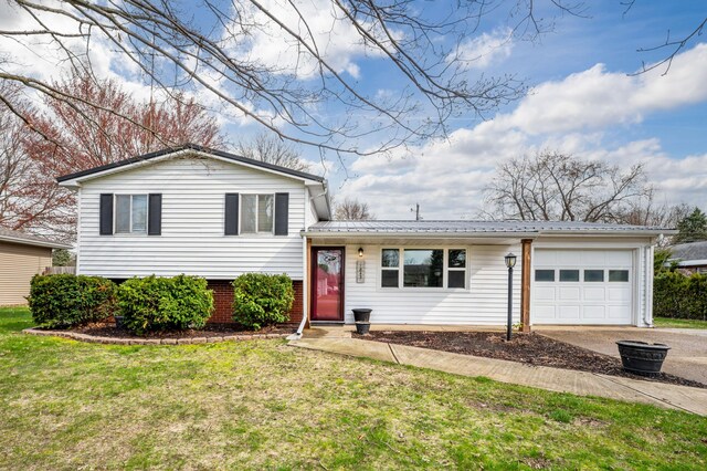 1843 N Sierra Way, Stevensville, MI 49127 - split level home featuring an attached garage, a front lawn, metal roof, and driveway