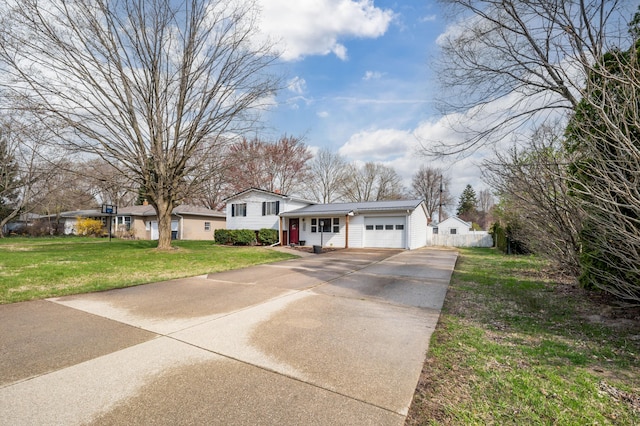 1843 N Sierra Way, Stevensville, MI 49127 - split level home with an attached garage, driveway, fence, and a front lawn