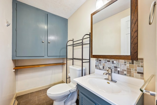 1843 N Sierra Way, Stevensville, MI 49127 - bathroom featuring a textured ceiling, tasteful backsplash, toilet, baseboard heating, and vanity
