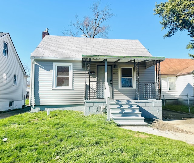 bungalow-style house featuring a front lawn, a porch, a chimney, and fence