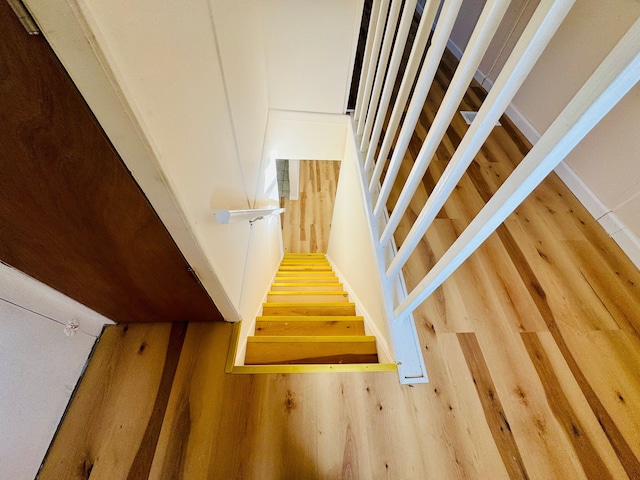stairway with wood finished floors