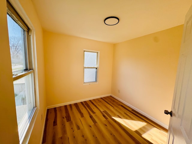 unfurnished room featuring wood finished floors and baseboards