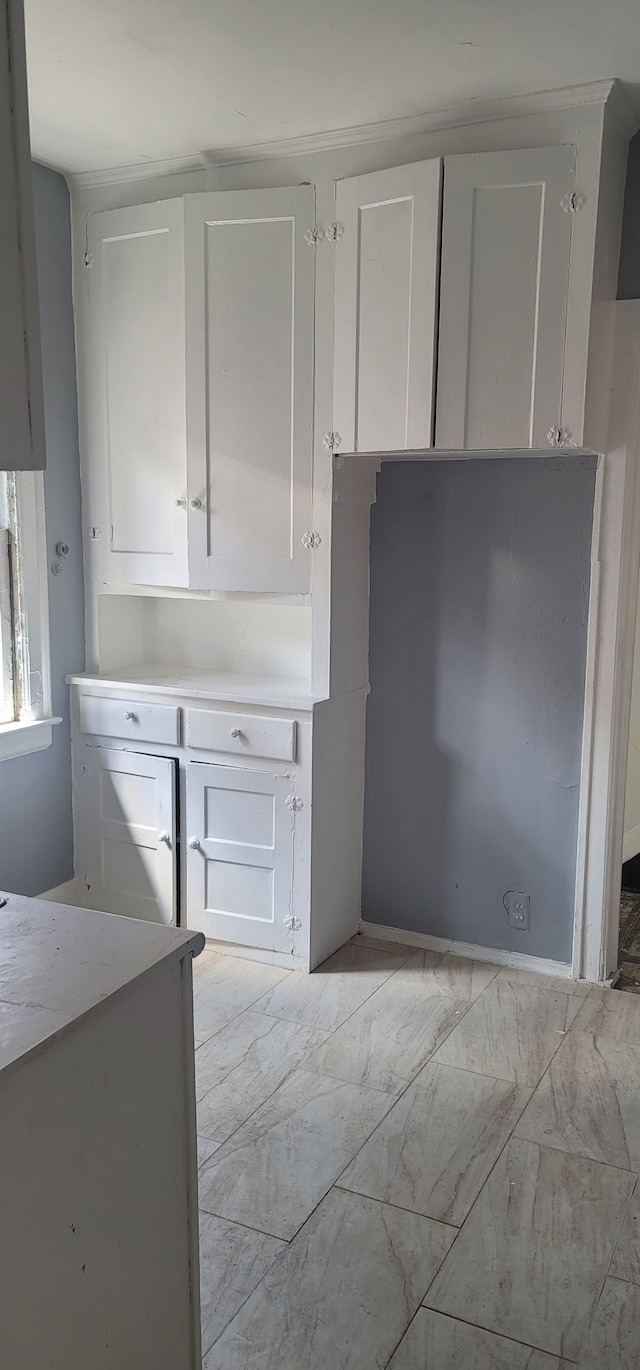 interior space featuring white cabinetry and light countertops