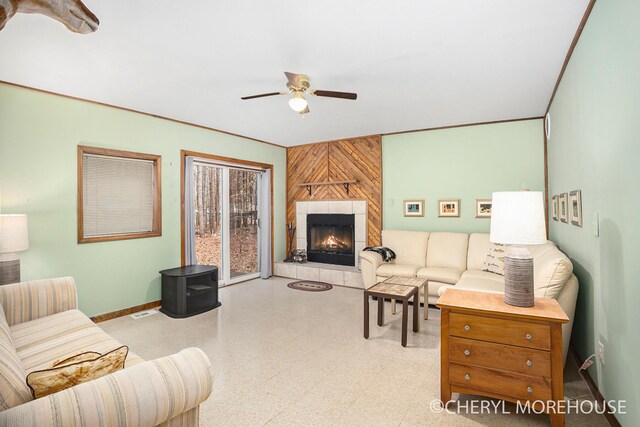3390 E Baseline Rd, White Cloud, MI 49349 - living area featuring ceiling fan, baseboards, visible vents, and a tiled fireplace