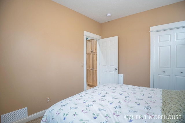 3390 E Baseline Rd, White Cloud, MI 49349 - bedroom featuring baseboards, visible vents, carpet, and a closet