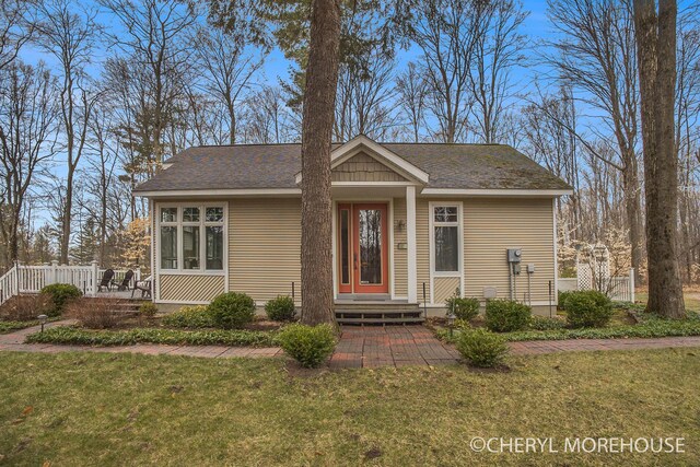 3390 E Baseline Rd, White Cloud, MI 49349 - view of front of home featuring roof with shingles and a front lawn