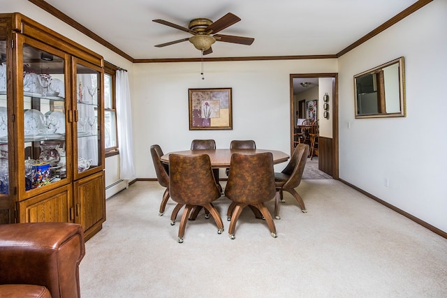 dining space featuring light colored carpet, baseboards, ceiling fan, and ornamental molding