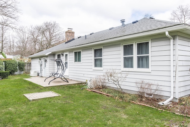back of house featuring fence, a yard, a patio, ac unit, and a chimney