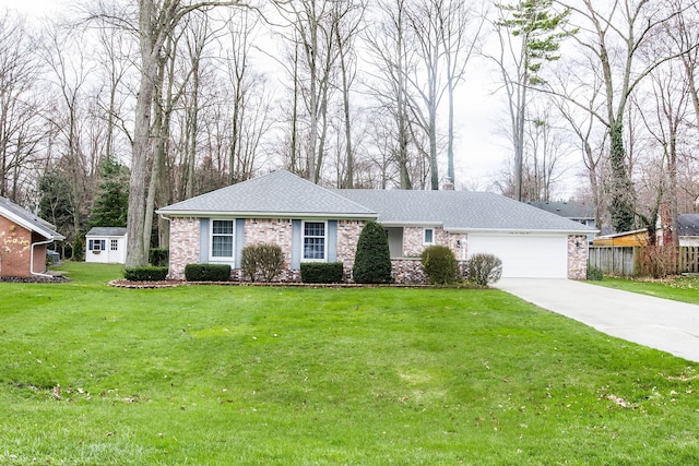 single story home with a chimney, a front yard, an attached garage, concrete driveway, and stone siding