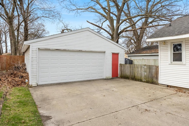 detached garage featuring fence
