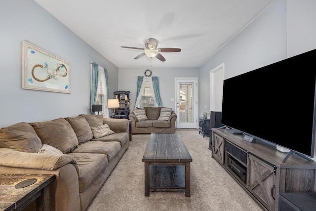 living room featuring a ceiling fan and light colored carpet