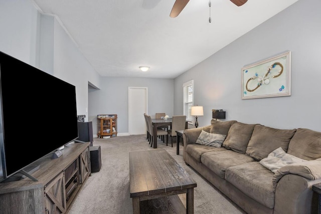 living area featuring light carpet and a ceiling fan