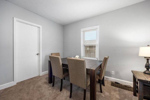 dining area with baseboards and carpet