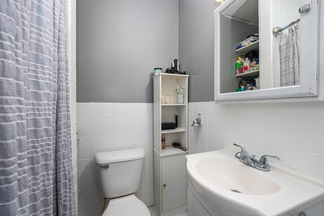 full bathroom with tile walls, wainscoting, vanity, and toilet