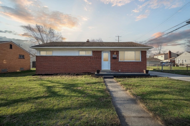 35333 Stellwagen St, Wayne, MI 48184 - bungalow with brick siding, fence, and a front yard