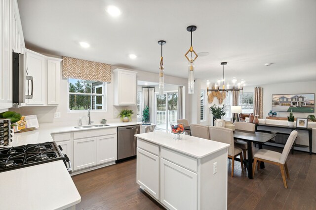 14331 Old Oak Trl, Van Buren, MI 48111 - kitchen featuring a sink, appliances with stainless steel finishes, dark wood-style floors, and a notable chandelier