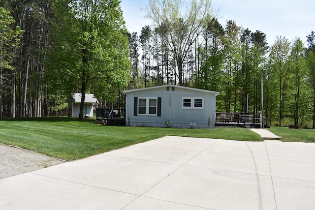 7885 W Fox Rd, Mears, MI 49436 - manufactured / mobile home featuring a deck, a front yard, and a patio area