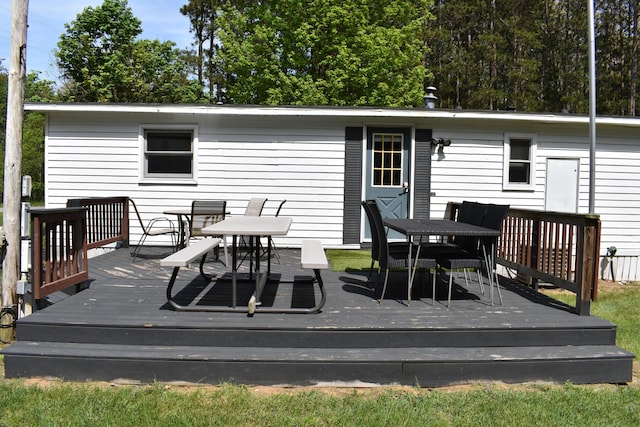 7885 W Fox Rd, Mears, MI 49436 - wooden terrace featuring outdoor dining area