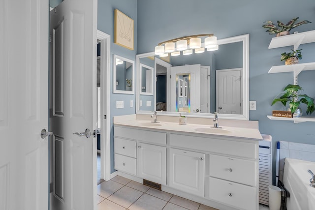 bathroom featuring double vanity, visible vents, tile patterned flooring, and a sink