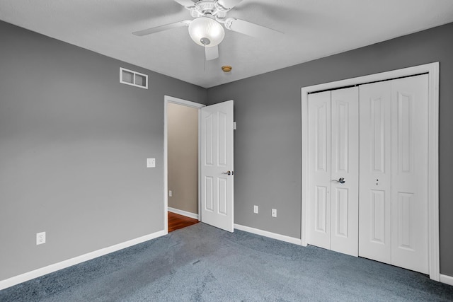 unfurnished bedroom featuring visible vents, a ceiling fan, carpet floors, a closet, and baseboards