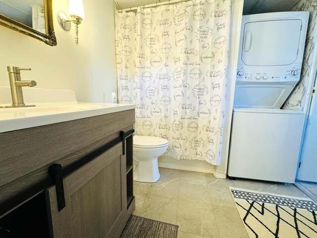 bathroom with stacked washer and dryer, toilet, and vanity